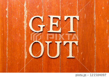 Alphabet letter in word get out on old red color wood plate background Alphabet letter in word get out on old red color wood plate background 121584097
