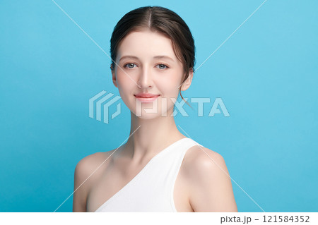 Beautiful young woman with clean fresh skin on blue background, Face care, Facial treatment, Cosmetology, beauty and spa, women portrait. 121584352