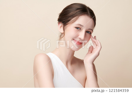 Beautiful young woman with clean fresh skin on beige background, Face care, Facial treatment, Cosmetology, beauty and spa, women portrait. Beautiful young woman with clean fresh skin on beige background, Face care, Facial treatment, Cosmetology, beauty and spa, women portrait. 121584359