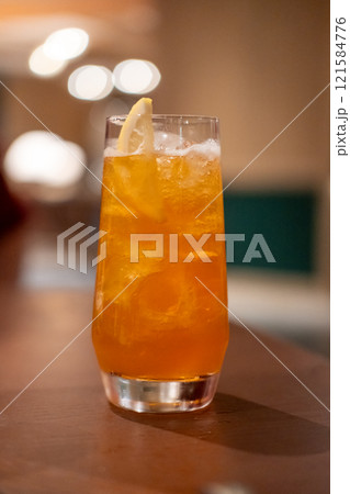 Close up view of orange cocktail on the table with bokeh background 121584776
