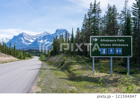 Road sign to Athabasca Falls on Icefields Parkway (Alberta Highway 93) in Jasper National Park, Alberta, Canada. Canadian Rockies summer landscape. Mount Fryatt and Geraldine Peak in the background. Road sign to Athabasca Falls on Icefields Parkway (Alberta Highway 93) in Jasper National Park, Alberta, Canada. Canadian Rockies summer landscape. Mount Fryatt and Geraldine Peak in the background. 121584847