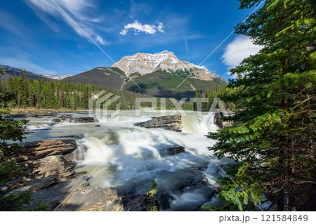 Athabasca Falls in Jasper National Park, Alberta, Canada. Canadian Rockies summer landscape. Mount Kerkeslin in the background. Athabasca Falls in Jasper National Park, Alberta, Canada. Canadian Rockies summer landscape. Mount Kerkeslin in the background. 121584849