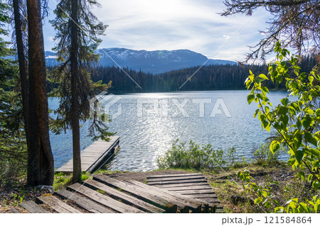Wooden dock on the lake shore. Leach Lake, Jasper National Park. Alberta, Canada. Canadian Rockies summer landscape. Wooden dock on the lake shore. Leach Lake, Jasper National Park. Alberta, Canada. Canadian Rockies summer landscape. 121584864