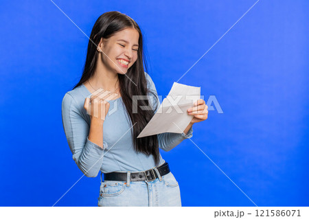 Happy Young woman open envelope take out letter reads, bank loan approve, great news, award, win Happy Young woman open envelope take out letter reads, bank loan approve, great news, award, win 121586071