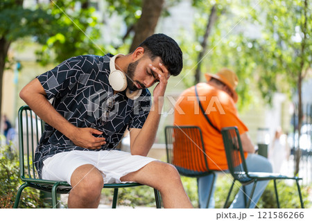 Indian man feeling sudden strong abdominal stomach liver kidney ache gastritis diarrhea outdoors Indian man feeling sudden strong abdominal stomach liver kidney ache gastritis diarrhea outdoors 121586266