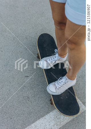 close up of skateboarders foot while skating 121586907