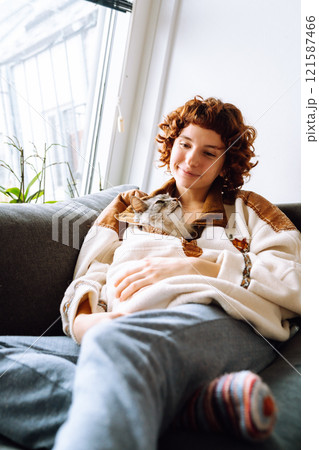 portrait young woman hugging gray fluffy domestic cat 121587466
