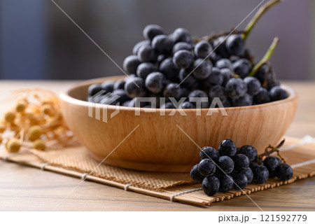 Black grapes in wooden bowl, Seedless grapes Black grapes in wooden bowl, Seedless grapes 121592779