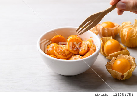 Cape gooseberry or Golden berry (Physalis peruviana) with chili powder and sugar, Spicy fruit salad 121592792