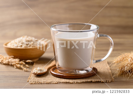 Oat milk in cup glass on wooden background, Alternative milk made from plant, non dairy 121592833
