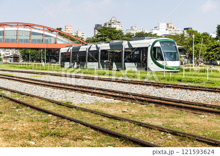 The circular light rail train drives past Hamasen Railway Cultural Park in Kaohsiung, Taiwan. 121593624
