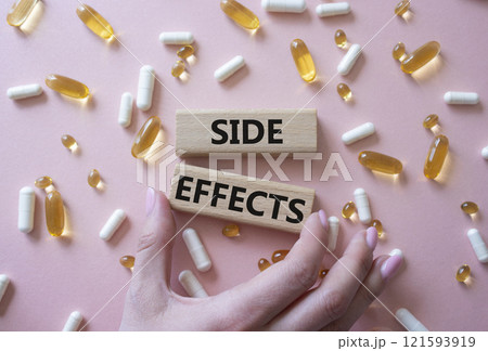 Side Effects symbol. Wooden blocks with words Side Effects. Beautiful pink background with pills. Doctor hand. Medicine and Side Effects concept. Copy space. Side Effects symbol. Wooden blocks with words Side Effects. Beautiful pink background with pills. Doctor hand. Medicine and Side Effects concept. Copy space. 121593919