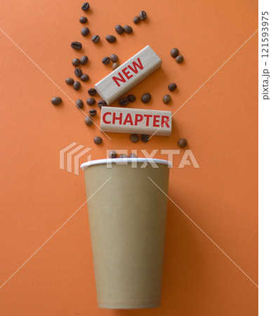 New Chapter symbol. Concept word New Chapter on wooden blocks. Beautiful orange background with coffee cup. Business and New Chapter concept. Copy space New Chapter symbol. Concept word New Chapter on wooden blocks. Beautiful orange background with coffee cup. Business and New Chapter concept. Copy space 121593975