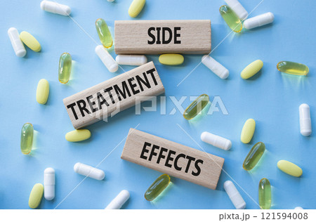 Side Treatment Effects symbol. Concept words Side Treatment Effects on wooden blocks. Beautiful blue background with pills. Healthcare and Side Treatment Effects concept. Copy space. 121594008