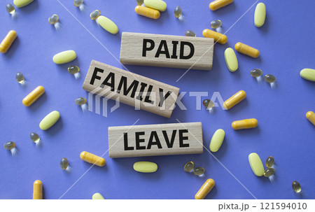 Paid Family Leave symbol. Concept words Paid Family Leave on wooden blocks. Beautiful purple background with pills. Healthcare and Paid Family Leave concept. Copy space. 121594010