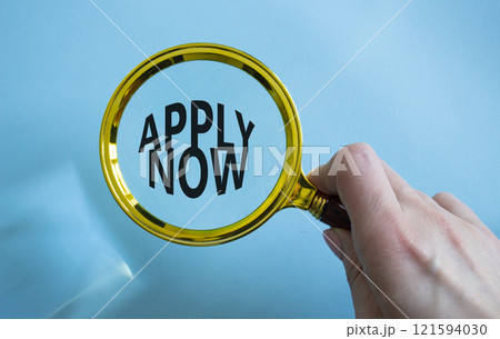 Apply now symbol. Magnifying Glass with Concept word Apply now. Beautiful blue background. Businessman hand. Business and Apply now concept. Copy space Apply now symbol. Magnifying Glass with Concept word Apply now. Beautiful blue background. Businessman hand. Business and Apply now concept. Copy space 121594030