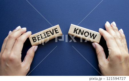 Believe or Know symbol. Concept word Believe or Know on wooden blocks. Businessman hand. Beautiful deep blue background. Business and Believe or Know concept. Copy space 121594727