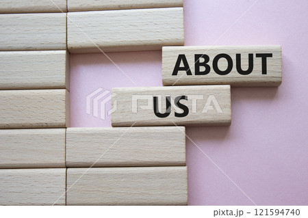 About us symbol. Wooden blocks with words About us. Beautiful pink background. Business and About us concept. Copy space. 121594740