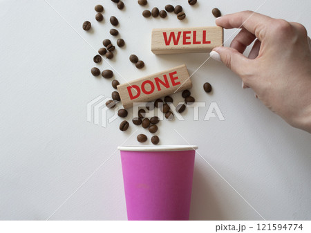 Well done symbol. Concept word Well done on wooden blocks. Businessman hand. Beautiful white background with coffee cup. Business and Well done concept. Copy space Well done symbol. Concept word Well done on wooden blocks. Businessman hand. Beautiful white background with coffee cup. Business and Well done concept. Copy space 121594774