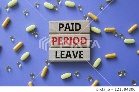 Paid Period Leave symbol. Concept words Paid Period Leave on wooden blocks. Beautiful purple background with pills. Healthcare and Paid Period Leave concept. Copy space. 121594800