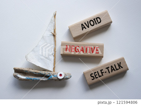 Avoid negative self-talk symbol. Concept words Avoid negative self-talk on wooden blocks. Beautiful white background with boat. Business and Avoid negative self-talk concept. Copy space. 121594806