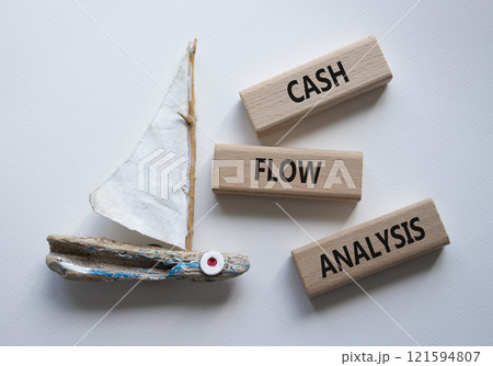 Cash Flow Analysis symbol. Concept words Cash Flow Analysis on wooden blocks. Beautiful white background with boat. Business and Cash Flow Analysis concept. Copy space. 121594807