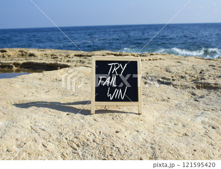 Try Fail Win symbol. Blackboard with words Try Fail Win. Beautiful sea background. Business and Try Fail Win concept. Copy space. Try Fail Win symbol. Blackboard with words Try Fail Win. Beautiful sea background. Business and Try Fail Win concept. Copy space. 121595420