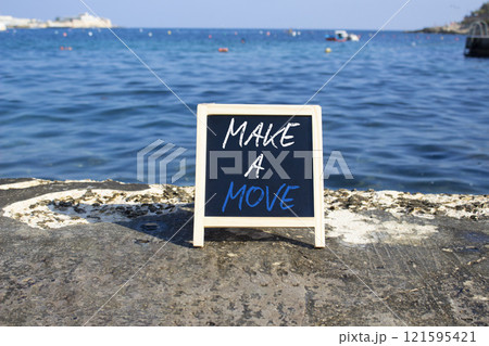 Make a Move symbol. Blackboard with Concept words Make a Move. Beautiful sea background. Business and Make a Move concept. Copy space. Make a Move symbol. Blackboard with Concept words Make a Move. Beautiful sea background. Business and Make a Move concept. Copy space. 121595421