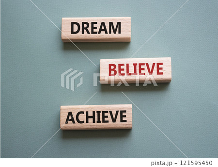 Dream Believe Achieve symbol. Wooden blocks with words Dream Believe Achieve. Beautiful grey green background. Business and Dream Believe Achieve concept. Copy space. 121595450
