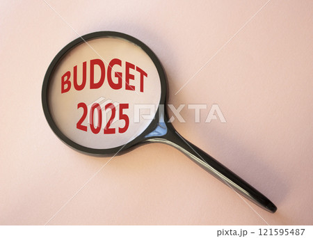 Budget 2025 symbol. Magnifying Glass with words Budget 2024. Beautiful pink background. Business and Budget 2025 concept. Copy space. 121595487