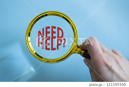 Need Help symbol. Magnifying Glass with Concept word Need Help. Businessman hand. Beautiful blue background. Business and Need Help concept. Copy space 121595500