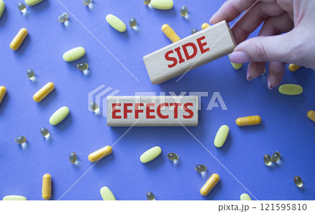 Side Effects symbol. Wooden blocks with words Side Effects. Beautiful purple background with pills. Doctor hand. Medicine and Side Effects concept. Copy space. Side Effects symbol. Wooden blocks with words Side Effects. Beautiful purple background with pills. Doctor hand. Medicine and Side Effects concept. Copy space. 121595810