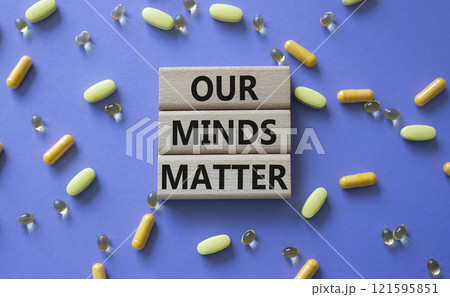Our Minds Matter symbol. Concept words Our Minds Matter on wooden blocks. Beautiful purple background with pills. Healthcare and Our Minds Matter concept. Copy space. 121595851