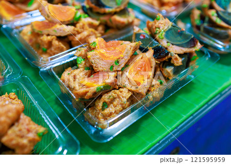 Top view of Fried Salted Egg Wrapped With Curried Fish Cake, focus selective Top view of Fried Salted Egg Wrapped With Curried Fish Cake, focus selective 121595959