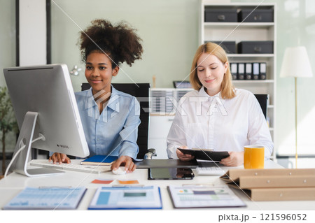 Diverse professionals collaborate on project analysis with financial graphs. Strategic teamwork and insights drive company growth and success. 121596052