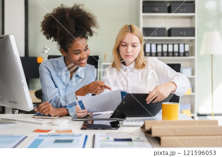 Diverse professionals collaborate on project analysis with financial graphs. Strategic teamwork and insights drive company growth and success. Diverse professionals collaborate on project analysis with financial graphs. Strategic teamwork and insights drive company growth and success. 121596053