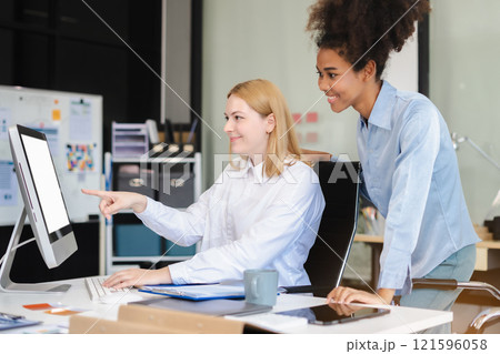 Diverse professionals collaborate on project analysis with financial graphs. Strategic teamwork and insights drive company growth and success. 121596058
