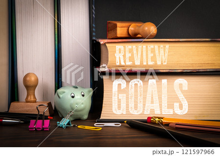 REVIEW and GOALS Concept. Stack of books on a wooden shelf 121597966