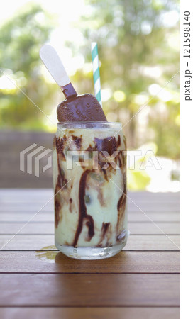 Avocado juice with chocolate lava and chocolate ice cream popsicle stick toppings. Avocado juice with chocolate lava and chocolate ice cream popsicle stick toppings. 121598140