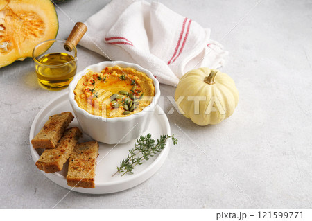 Homemade pumpkin chickpea hummus in a white bowl on light background 121599771