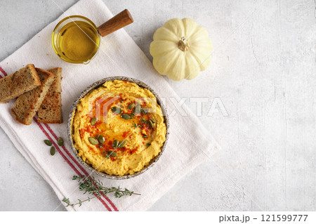 Homemade pumpkin chickpea hummus in a bowl on light background.Top view, copy space for recepie Homemade pumpkin chickpea hummus in a bowl on light background.Top view, copy space for recepie 121599777