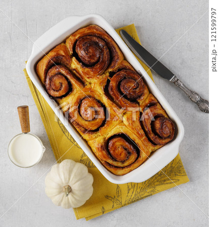 Cinnamon bun roll with pumpkin in plate. Homemade autumn Oven bakery desert for breakfast, top view, 121599797
