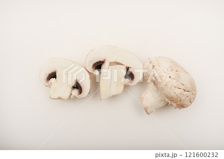 Fresh champignons on a white plate. Mushrooms on a white background. Fresh champignons on a white plate. Mushrooms on a white background. 121600232
