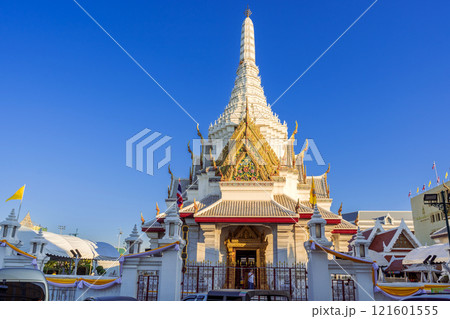 The Bangkok City Pillar Shrine exterior features traditional Thai architecture with intricate details and a towering spire, under a clear blue sky. The Bangkok City Pillar Shrine exterior features traditional Thai architecture with intricate details and a towering spire, under a clear blue sky. 121601555
