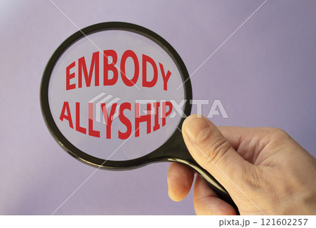 Embody Allyship symbol. Concept word Embody Allyship on magnifying glass. Beautiful purple background. Businessman hand. Business and Embody Allyship concept. Copy space Embody Allyship symbol. Concept word Embody Allyship on magnifying glass. Beautiful purple background. Businessman hand. Business and Embody Allyship concept. Copy space 121602257