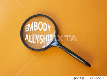 Embody Allyship symbol. Concept word Embody Allyship on magnifying glass. Beautiful orange background. Business and Embody Allyship concept. Copy space Embody Allyship symbol. Concept word Embody Allyship on magnifying glass. Beautiful orange background. Business and Embody Allyship concept. Copy space 121602263