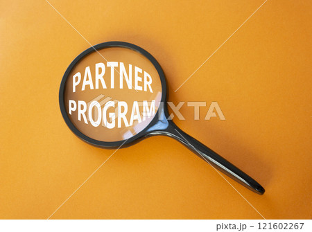 Partner Program symbol. Concept words Partner Program on magnifying glass. Beautiful orange background. Business and Partner Program concept. Copy space. Partner Program symbol. Concept words Partner Program on magnifying glass. Beautiful orange background. Business and Partner Program concept. Copy space. 121602267