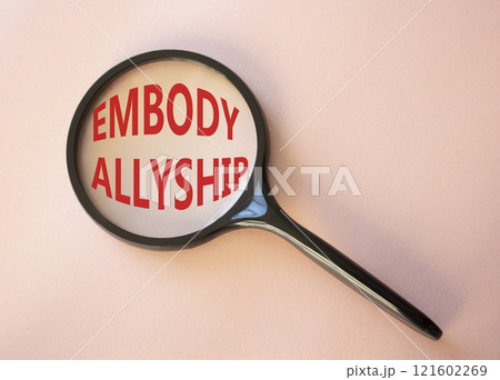 Embody Allyship symbol. Concept word Embody Allyship on magnifying glass. Beautiful pink background. Business and Embody Allyship concept. Copy space 121602269