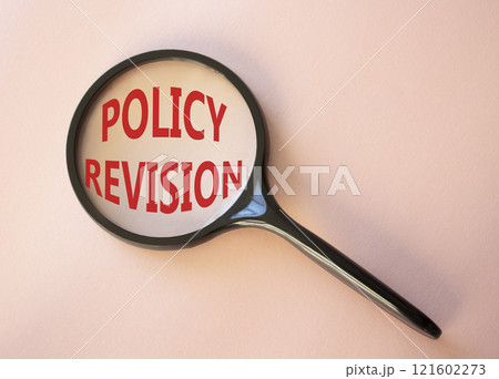 Policy revision symbol. Concept word Policy revision on magnifying glass. Beautiful pink background. Business and Policy revision concept. Copy space 121602273