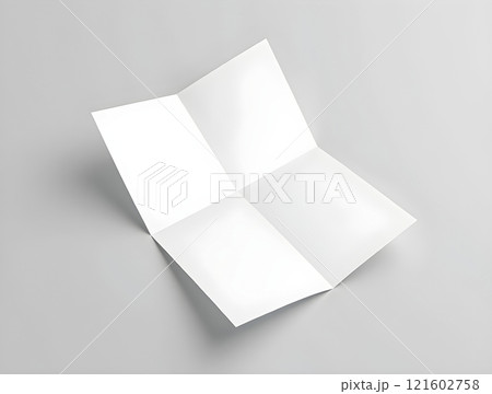 Blank folded paper sitting on a gray surface ready for creative use in various projects and designs 121602758